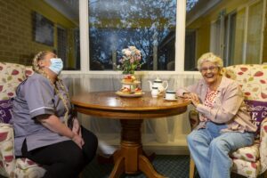 Resident and team member laughing