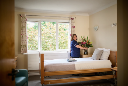 staff preparing flowers on residents bedside