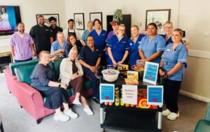 careers posing for a group photo in the care home