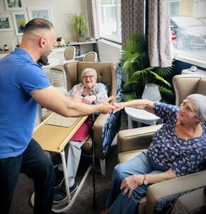 care worker holding residents hands
