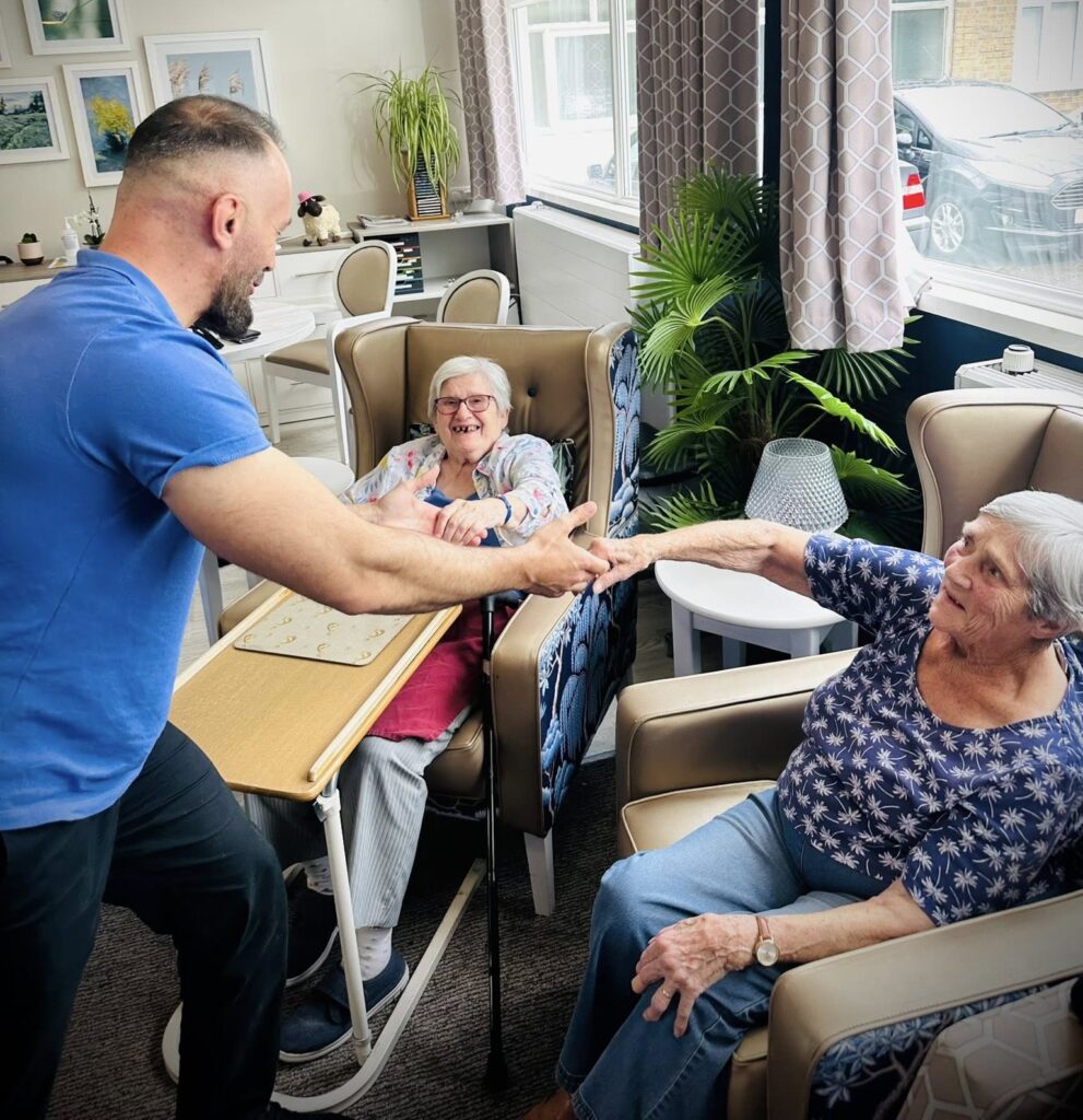 care worker holding residents hands