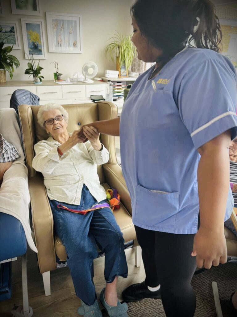carer hold care residents hand