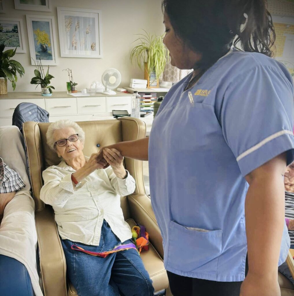 carer hold care residents hand
