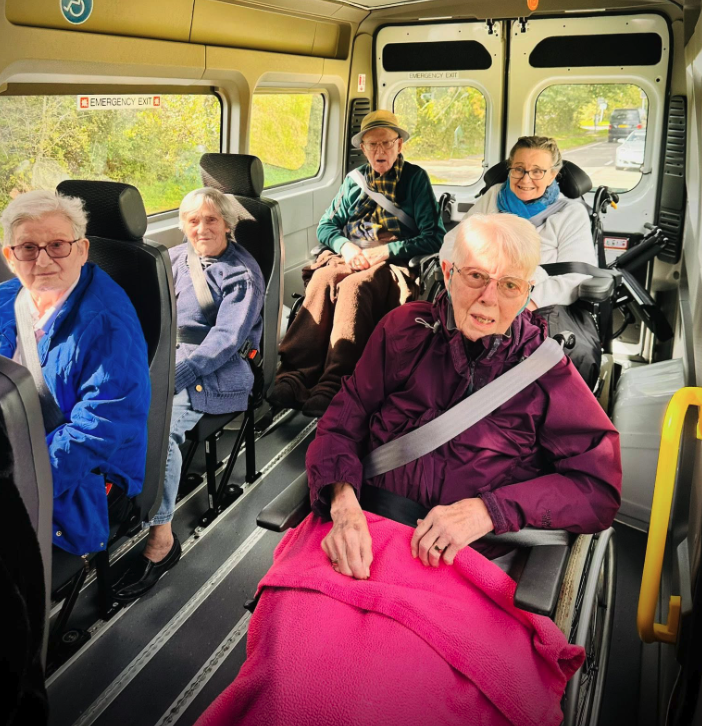 residents in the back of the care home mini bus