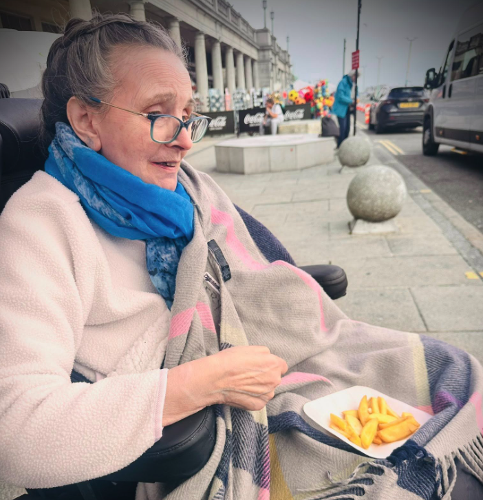 female resident eating chips at brighton beach