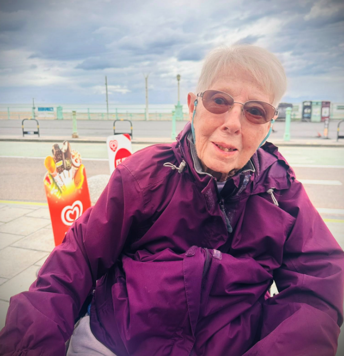 female resident selfie brighton beach wearing a purple rain jacket
