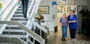 care home nurse walking with resident